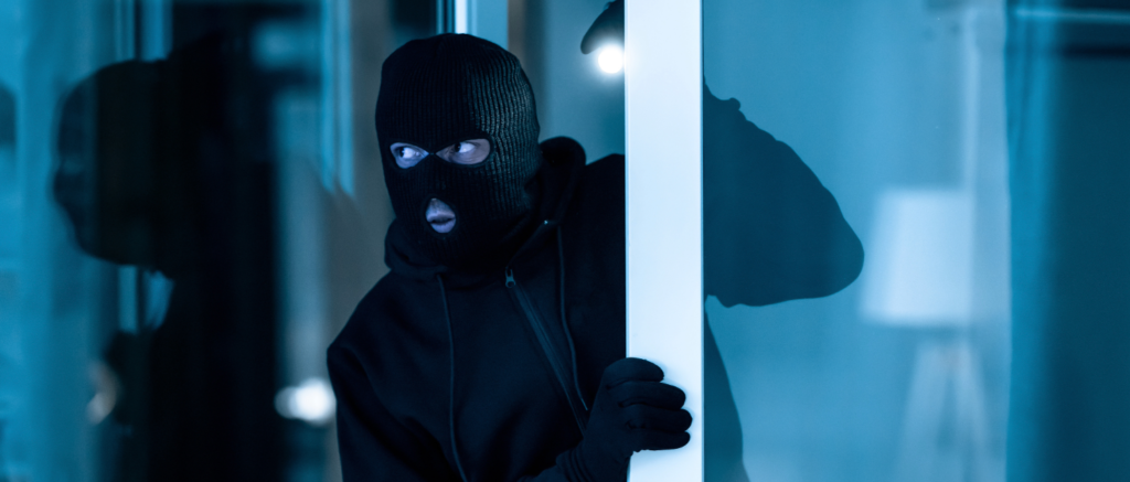 Burglar attempting break-in highlighting door lock security
