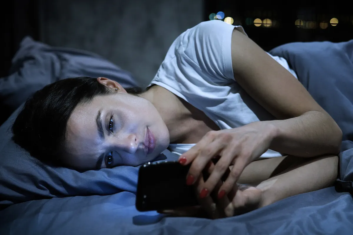 Checking the door lock from bed at night on a phone