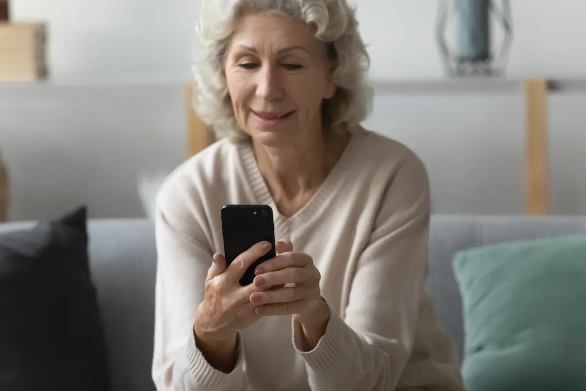 Older woman reassured by a message on her phone
