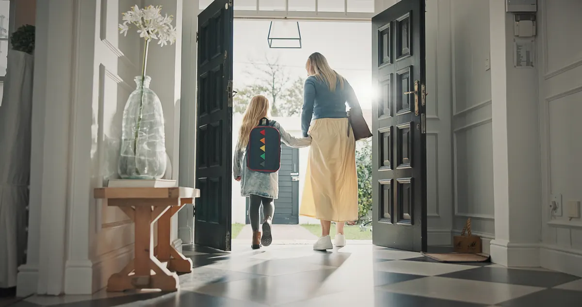Parent and child leaving through the front door